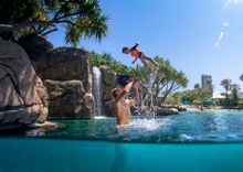 Dad and son playing at Surfers Paradise Marriott Resort & Spa pool