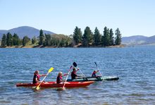Family enjoying a scenic kayak on Lake Jindabyne in the Snowy Mountains.