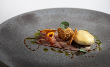 Plated gourmet dish from Lumiere featuring meat and creamy mash