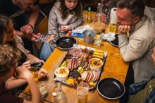 A wooden platter featuring an assortment of meats and BBQ sides - The Beefy Boys 2025 A wooden platter featuring an assortment of meats and BBQ sides - The Beefy Boys 2025