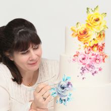 Natasha Collins using SK edible paint on a cake