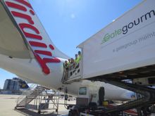 Gate Gourmet, EcoSlice and Virgin Australia reps standing on an aircraft ramp