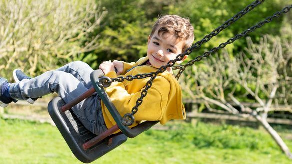 Child on swing at Kent Life Heritage Farm Park Child on swing at Kent Life Heritage Farm Park